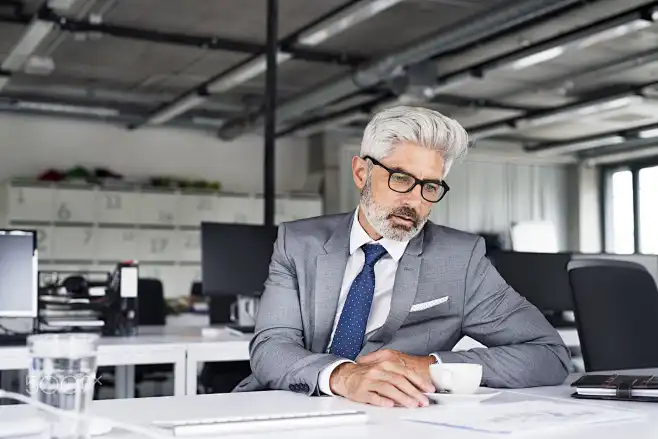 mature businessman in gray suit in the office.