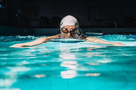 professional woman swimmer swim using breaststroke technique on