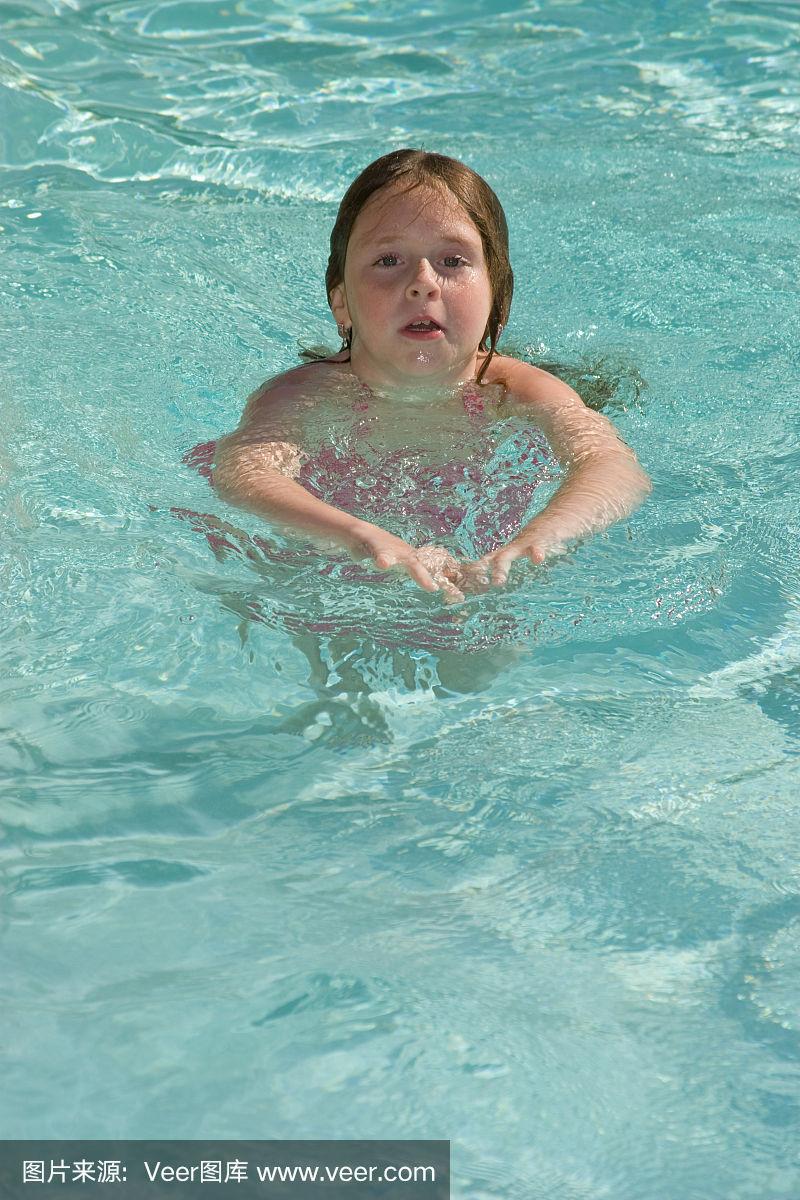 小女孩在游泳池里游泳